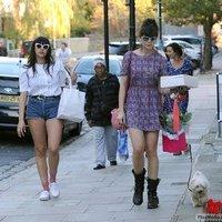 Daisy Lowe and a female companion walking her pet dog